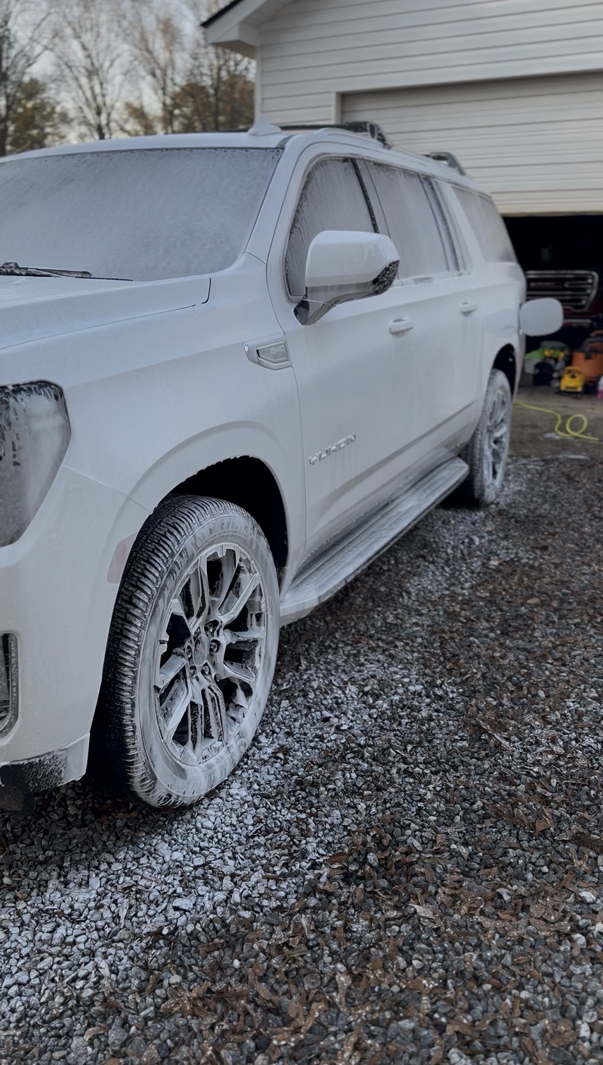 White GMC Yukon foam wash